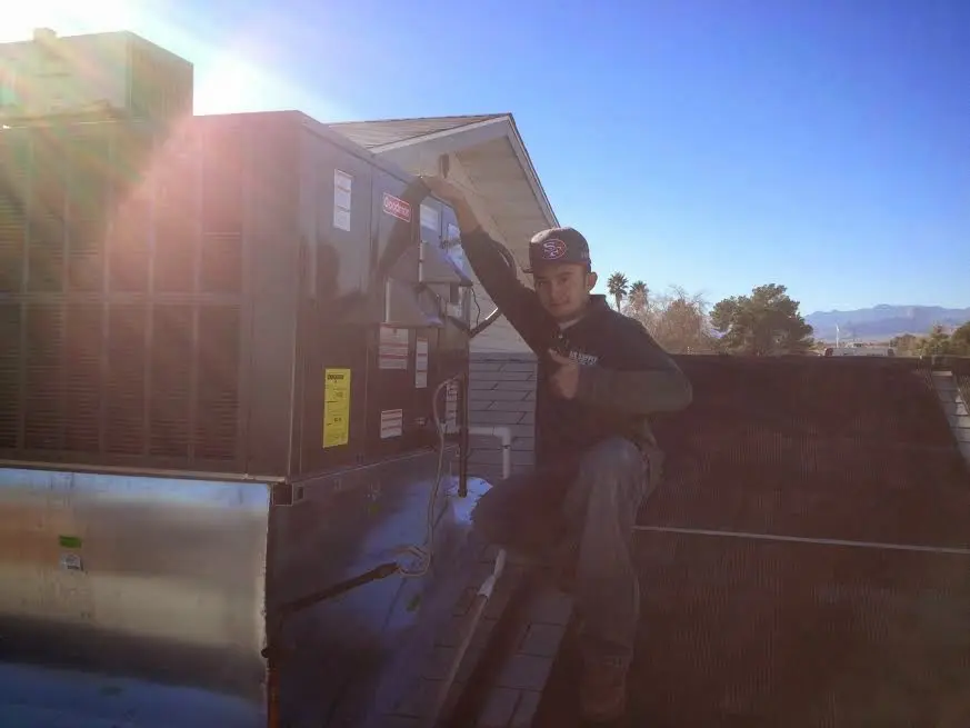 HVAC technician performing Air Duct Cleaning on a rooftop unit in Nashville